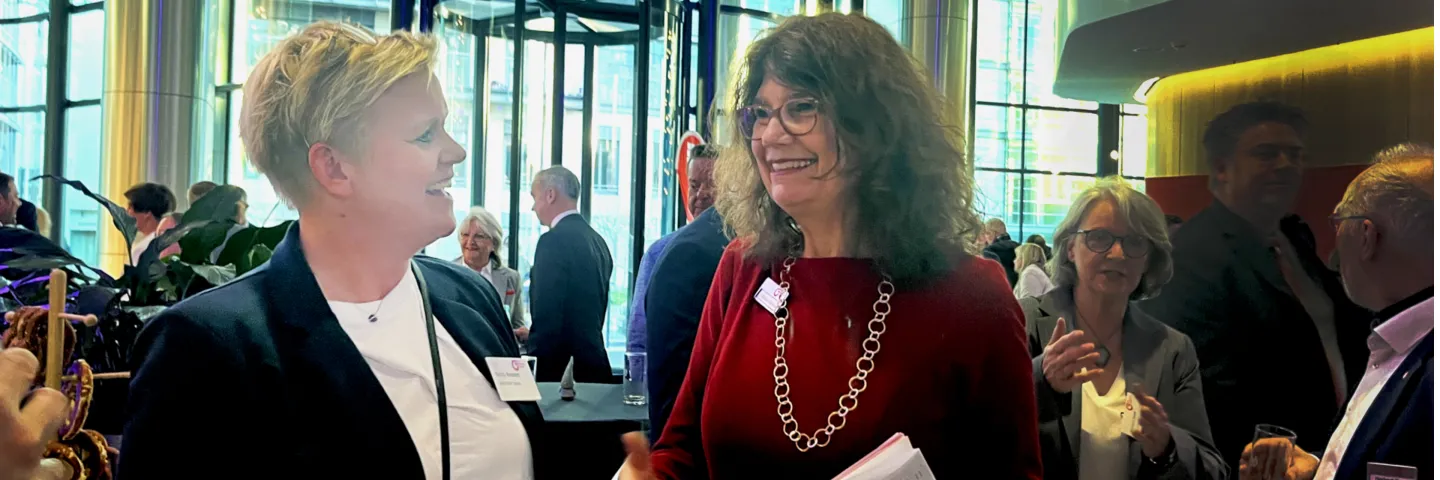 Two female leaders talking and smiling