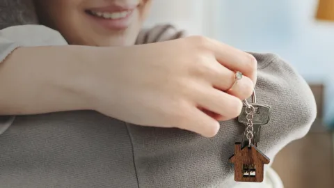 Woman holding keys to new house